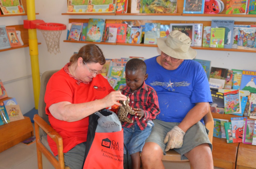 Becki and Bruce with John, the child they sponsor 